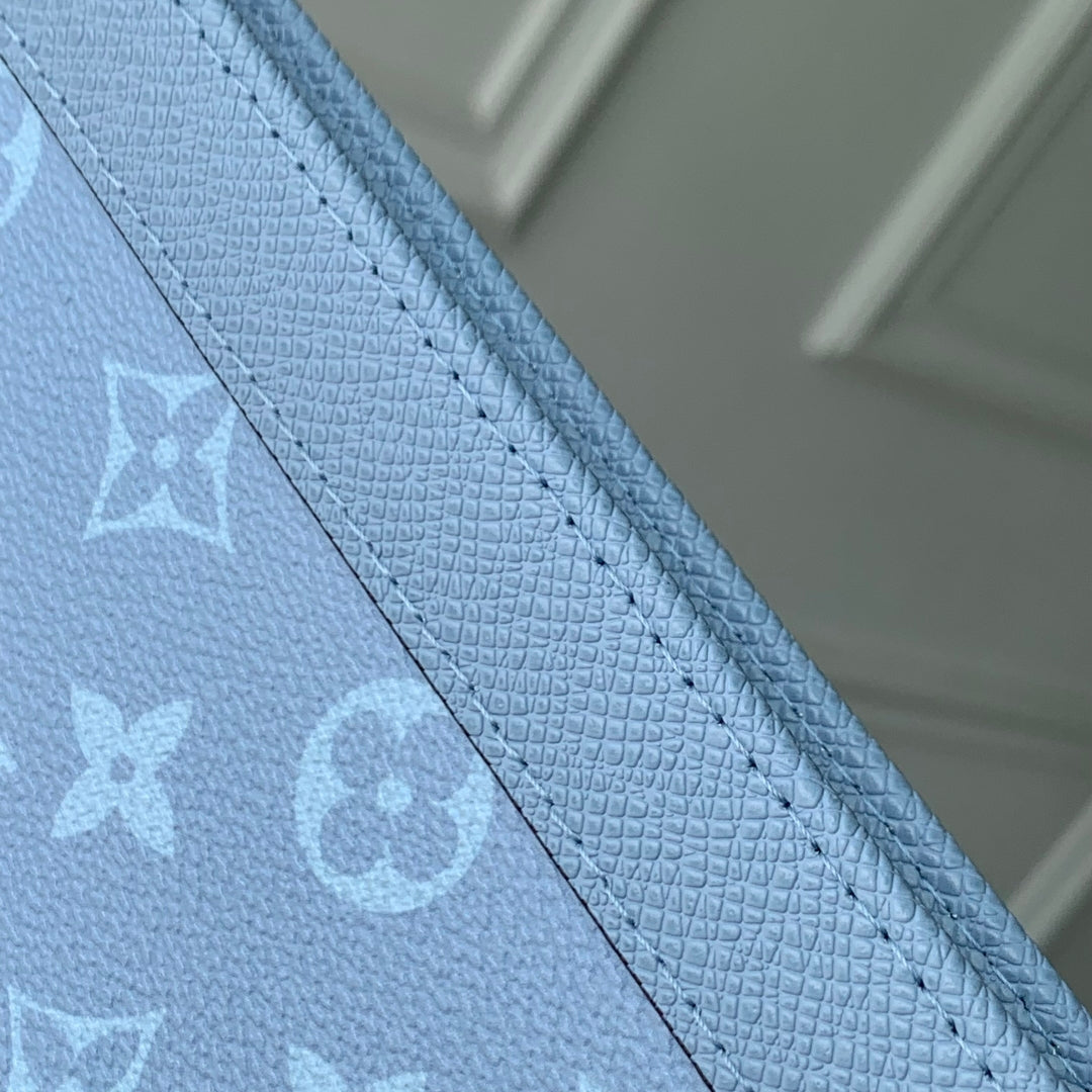 POCHETTE VOYAGE 26 IN LIGHT BLUE MONOGRAM ECLIPSE CALFSKIN