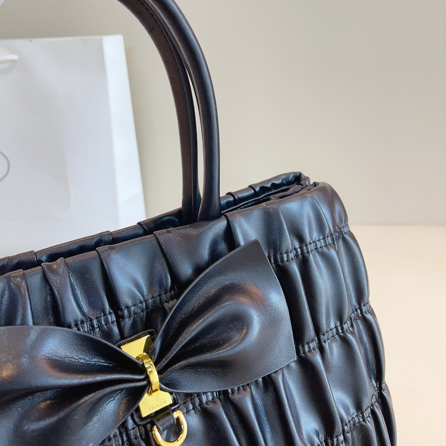 BOW DETAIL RUCHED TOP HANDLE BAG 29 IN BLACK SAFFIANO LEATHER