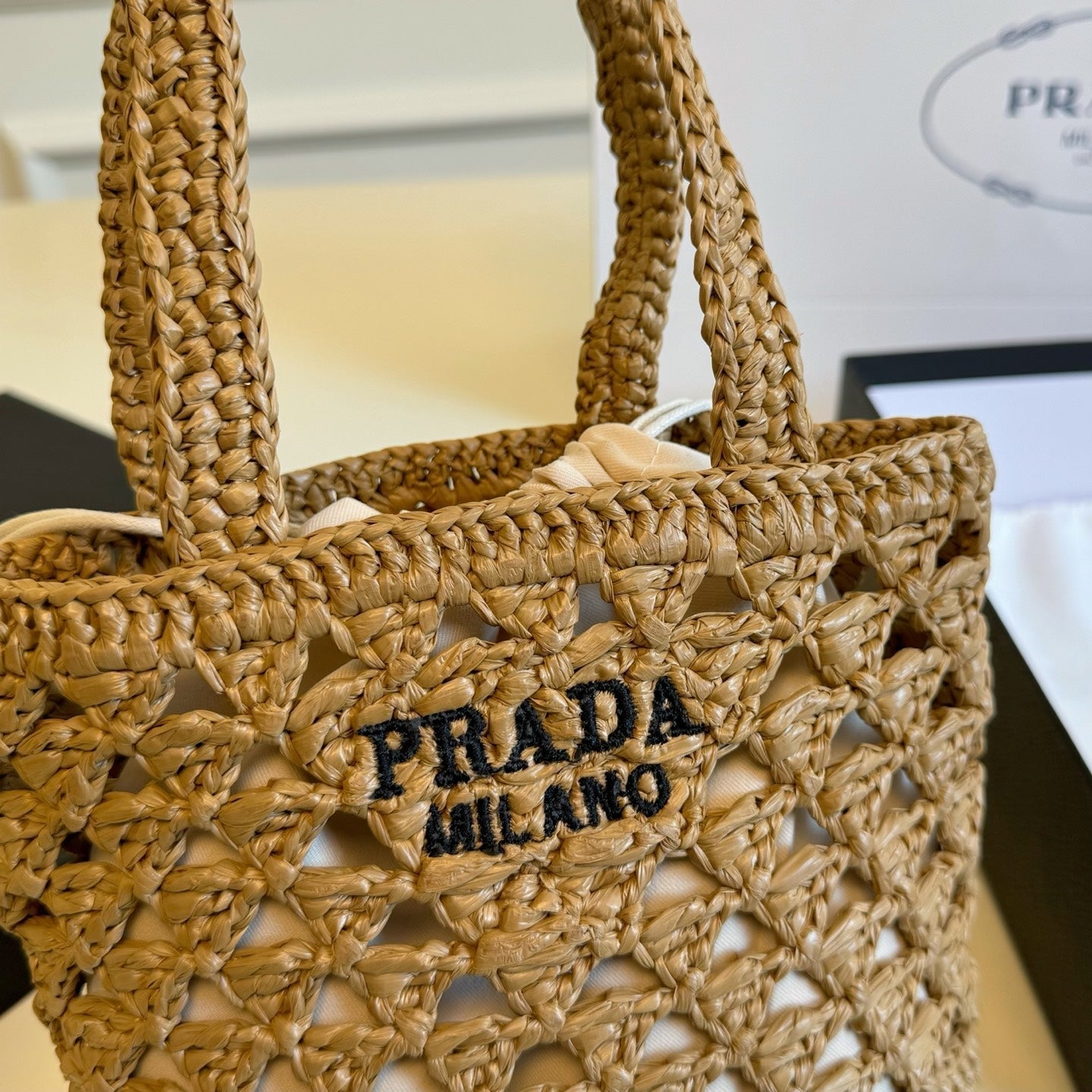 CROCHET BUCKET BAG 32 IN BROWN WOVEN RAFFIA EMBROIDED LOGO