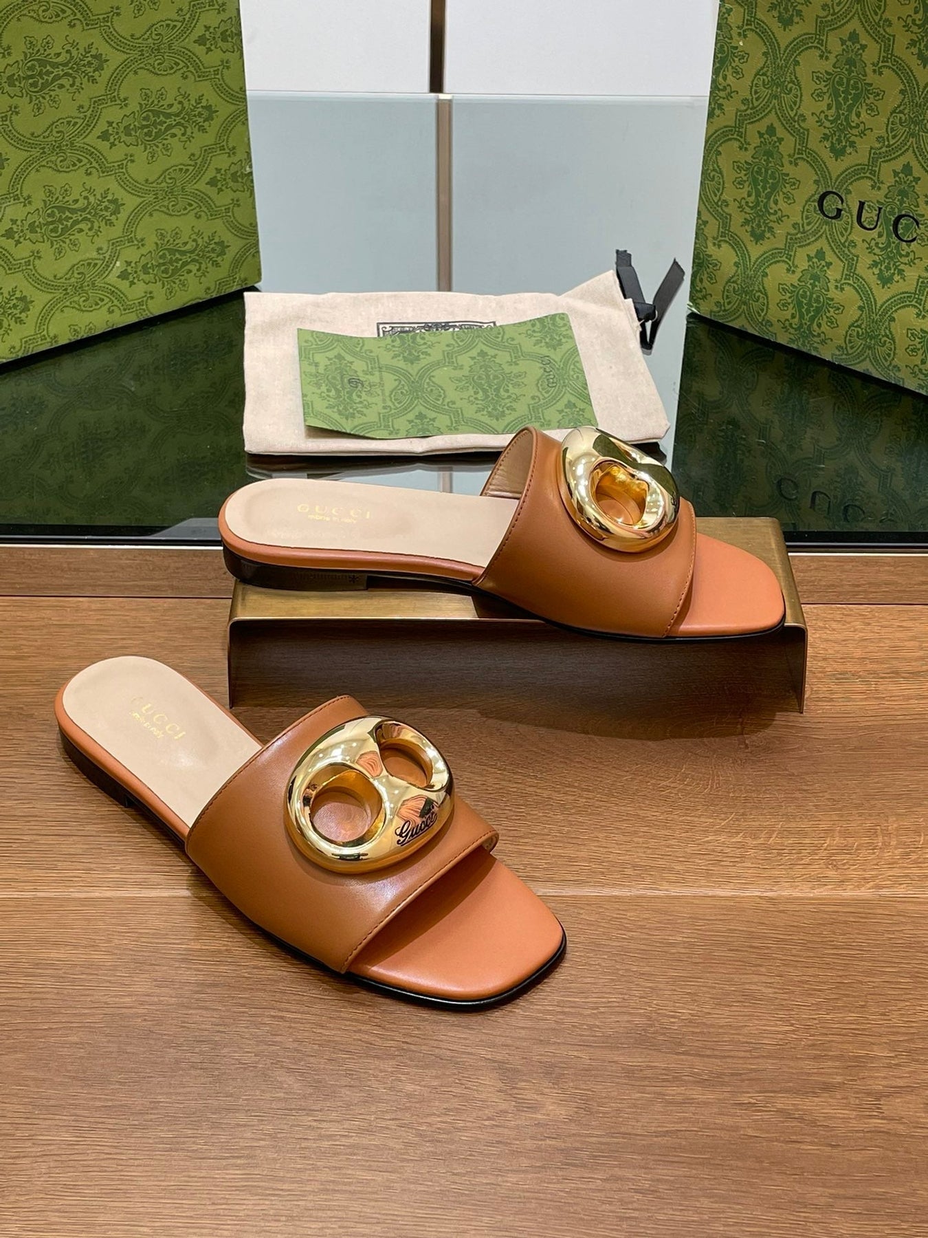 FLAT MULE IN BRONE BROWN CALFSKIN WITH GOLD HARDWARE