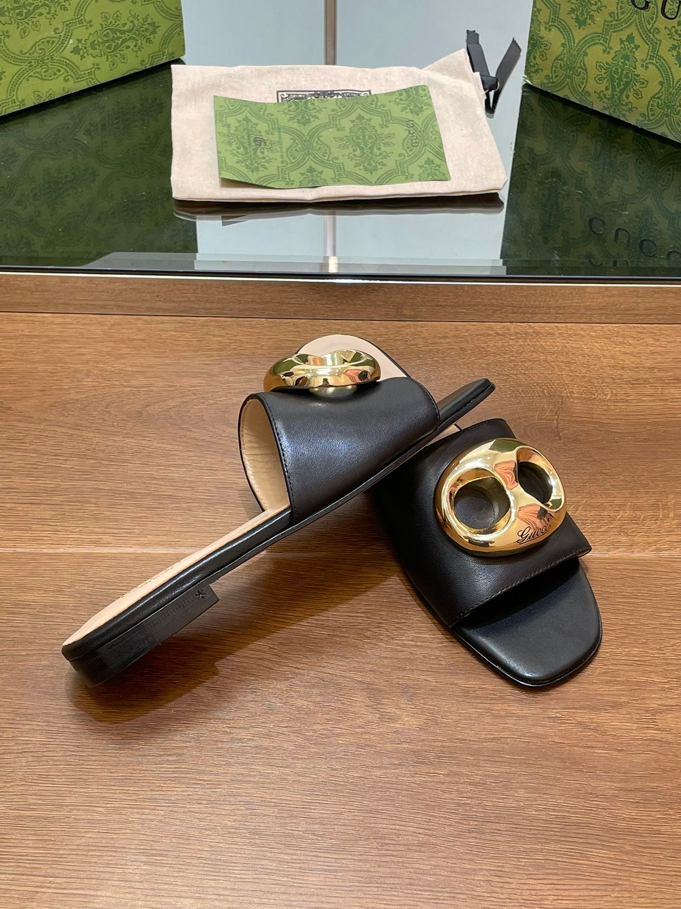 FLAT MULE IN BLACK CALFSKIN WITH GOLD HARDWARE