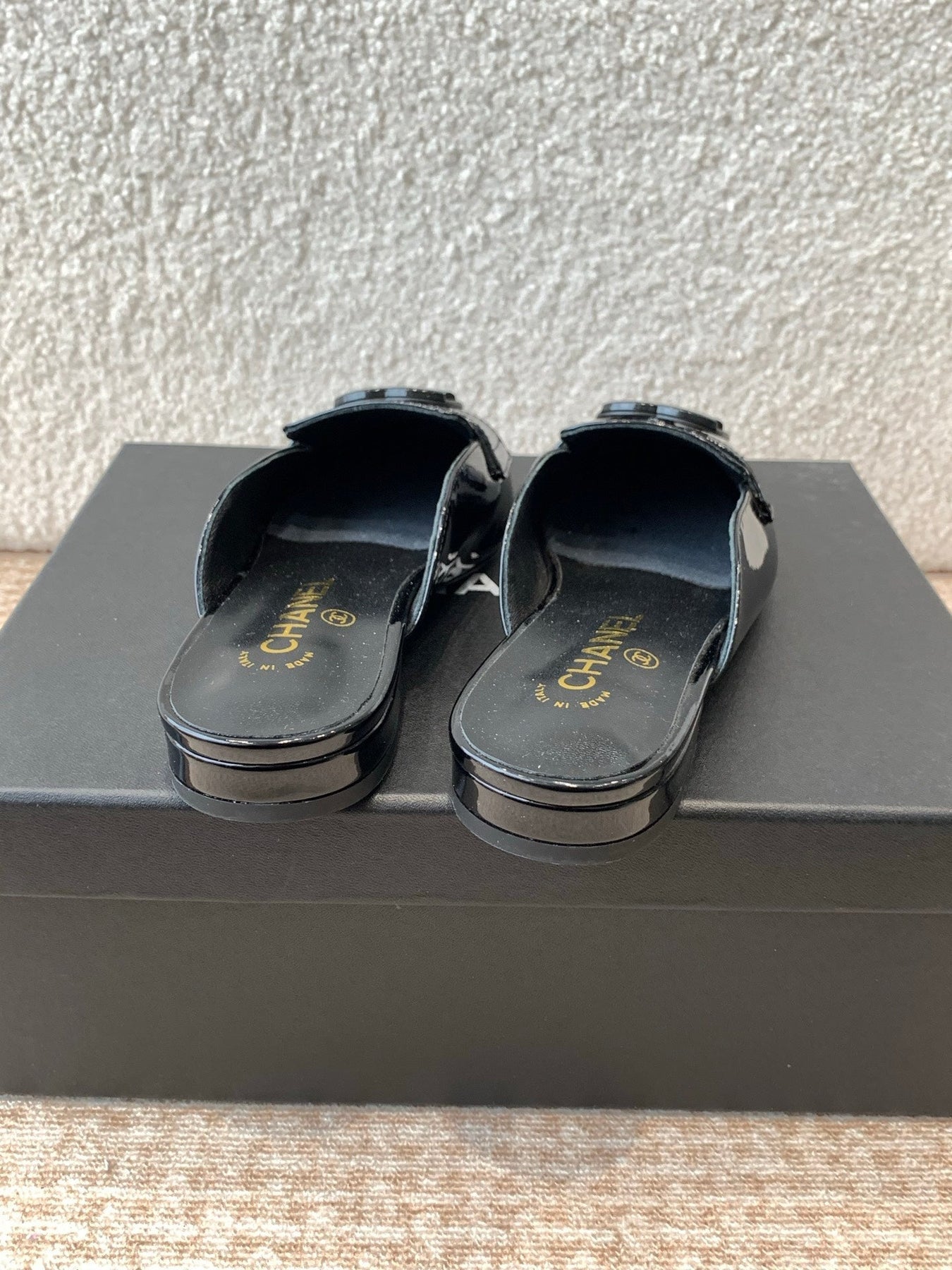 FLAT MULES IN BLACK PATENT CALFSKIN