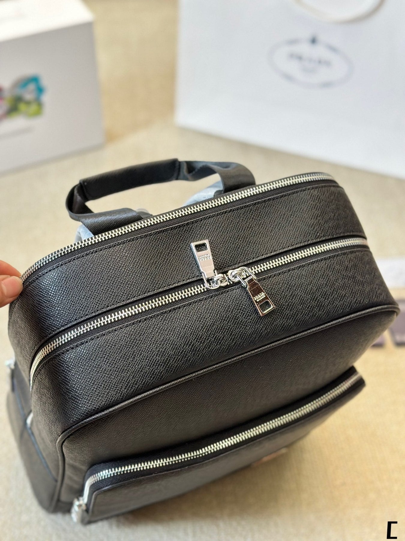 FRONT ZIP POCKET BACKPACK 38 IN BLACK GRAINED CALFSKIN