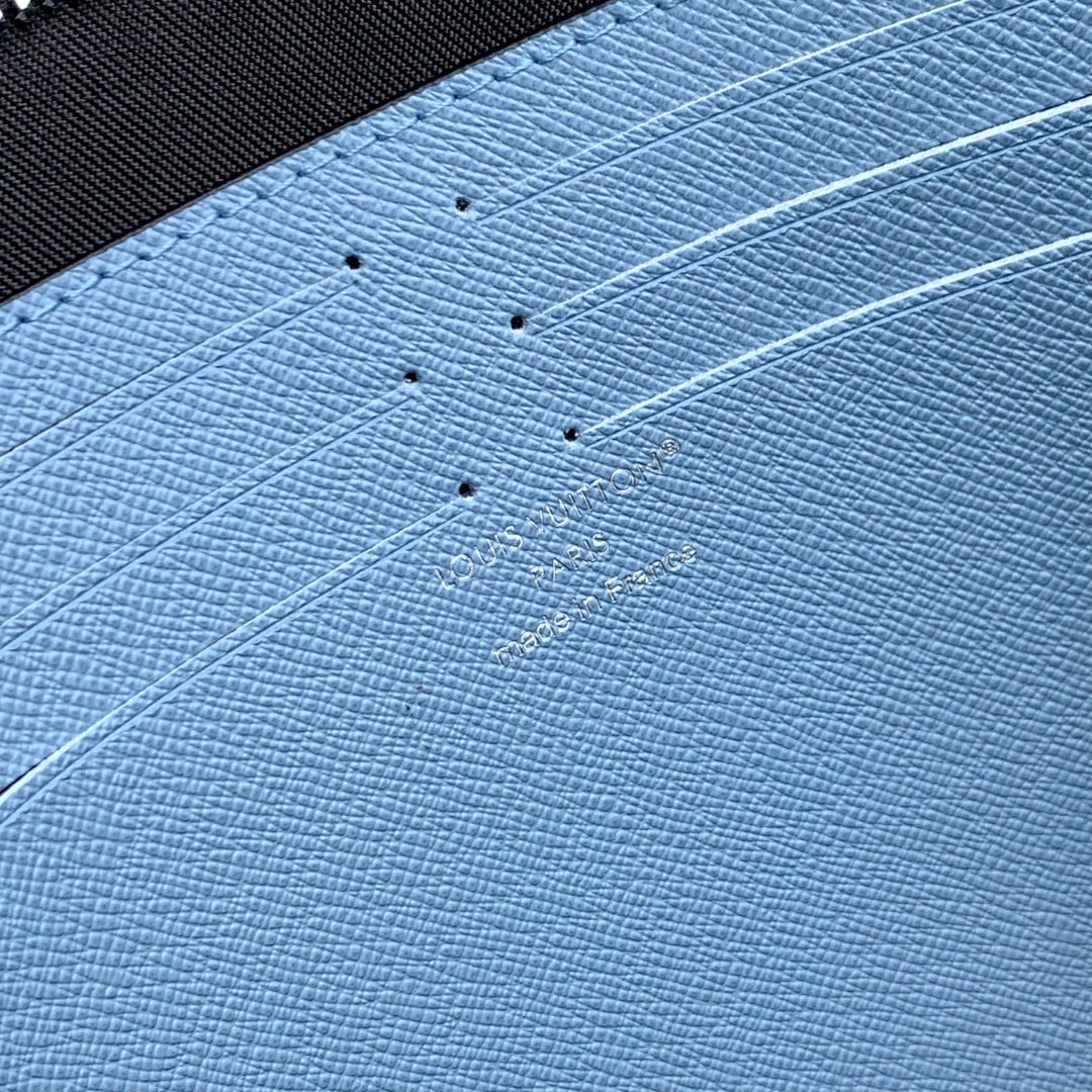 POCHETTE VOYAGE 26 IN LIGHT BLUE MONOGRAM ECLIPSE CALFSKIN