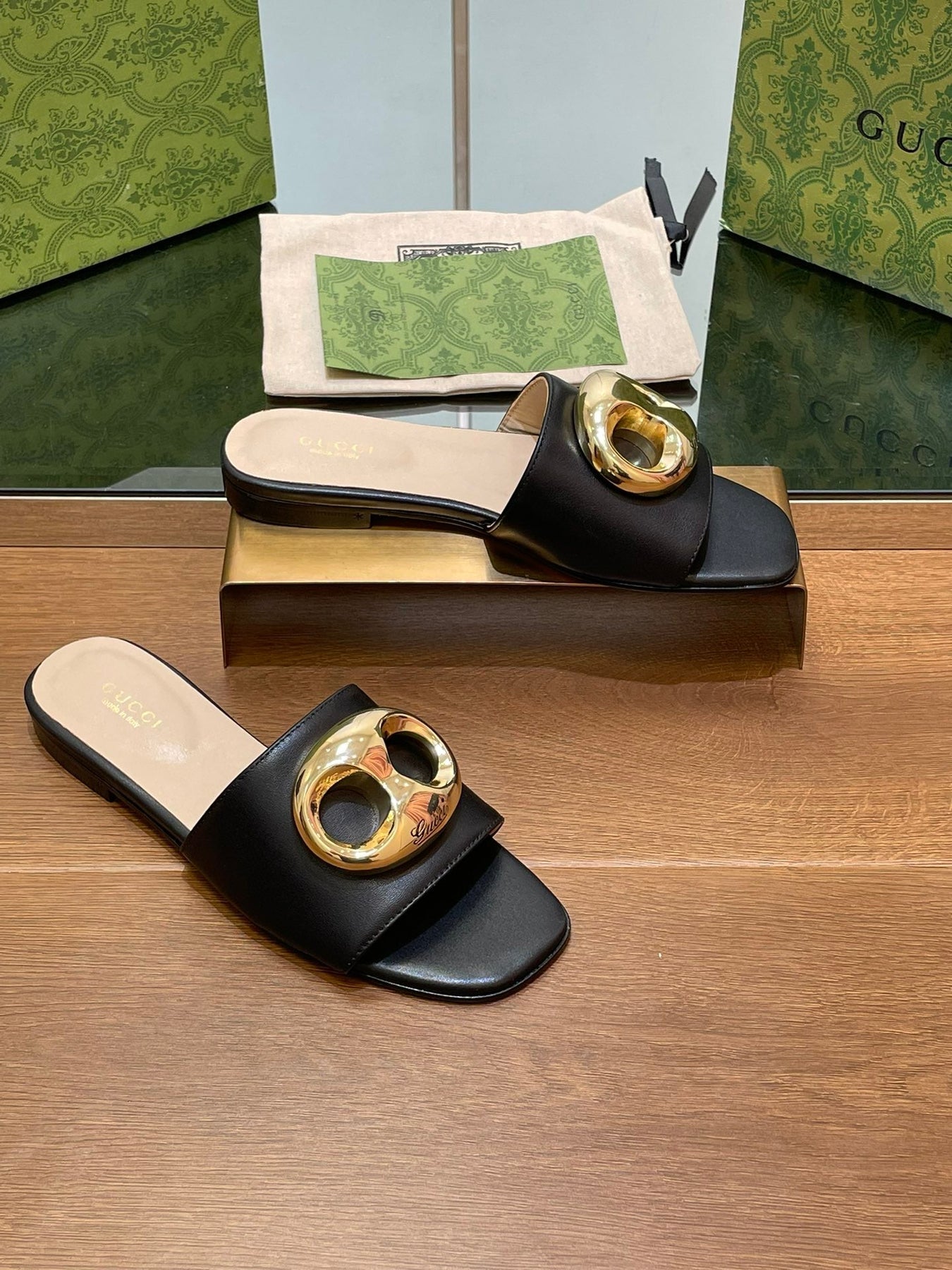 FLAT MULE IN BLACK CALFSKIN WITH GOLD HARDWARE