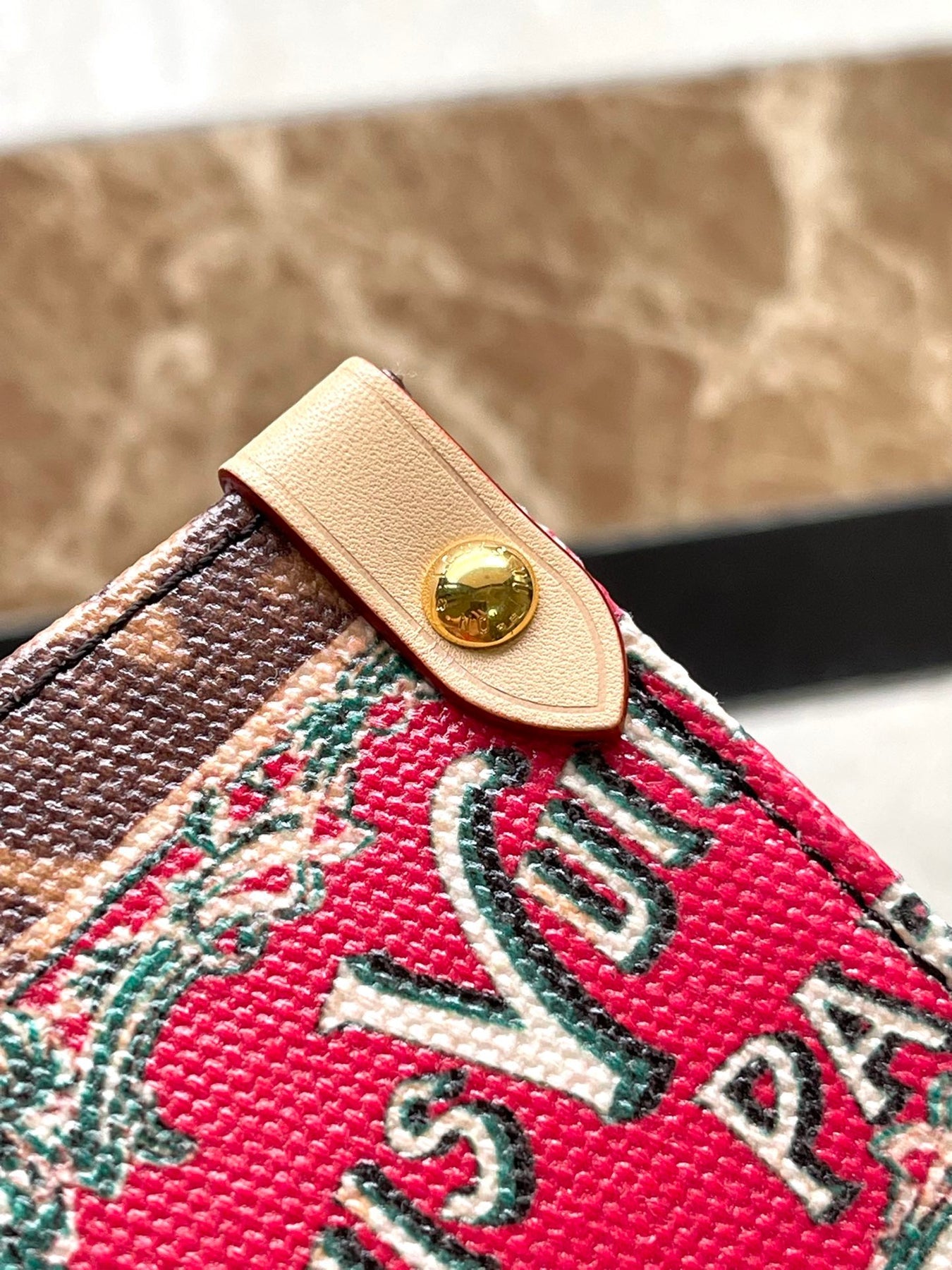 ONTHEGO VOYAGE 35 IN BROWN MONOGRAM CANVAS WITH VINTAGE HOTEL LABELS