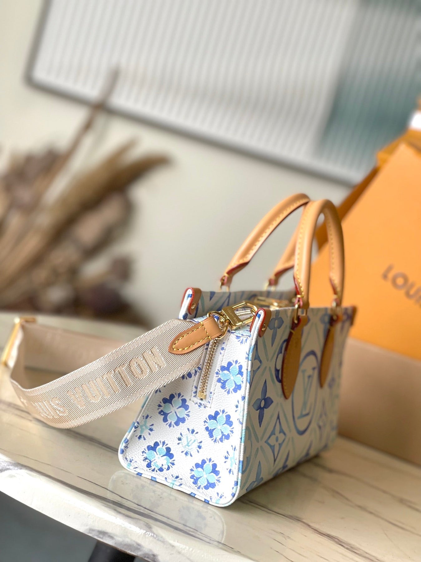 ONTHEGO EAST WEST 25 IN LAGOON BLUE MONOGRAM TILES CANVAS